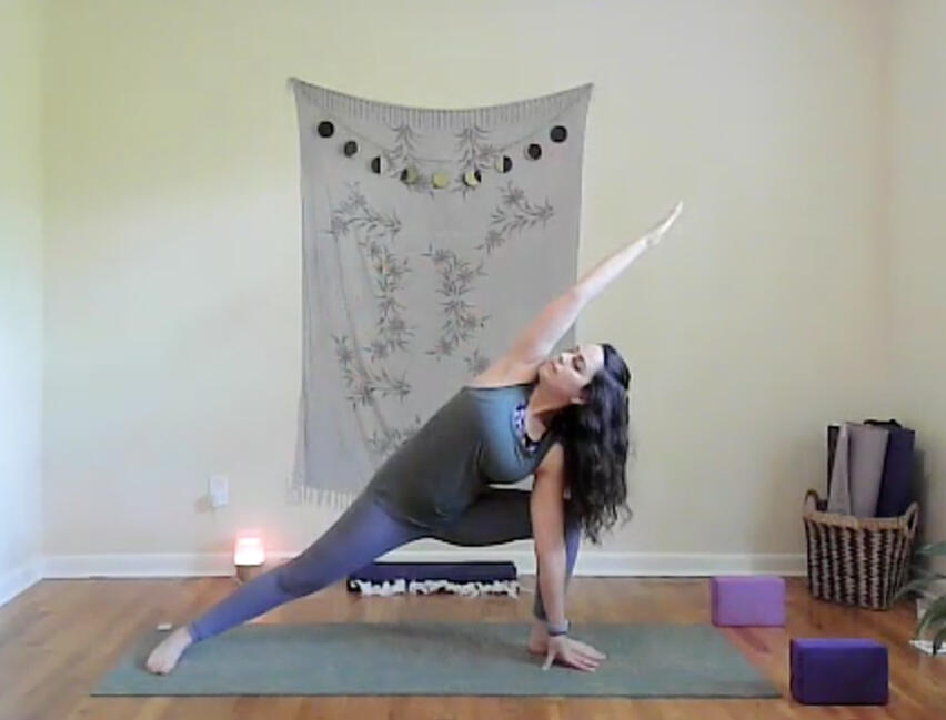 a woman in extended side angle yoga pose